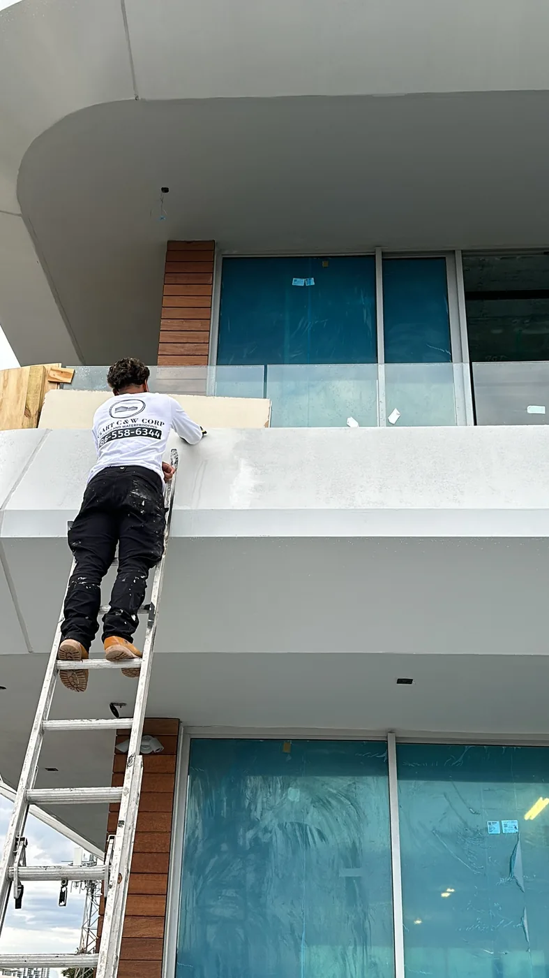 Smart Caulking & Waterproofing technician working on a South Florida building exterior